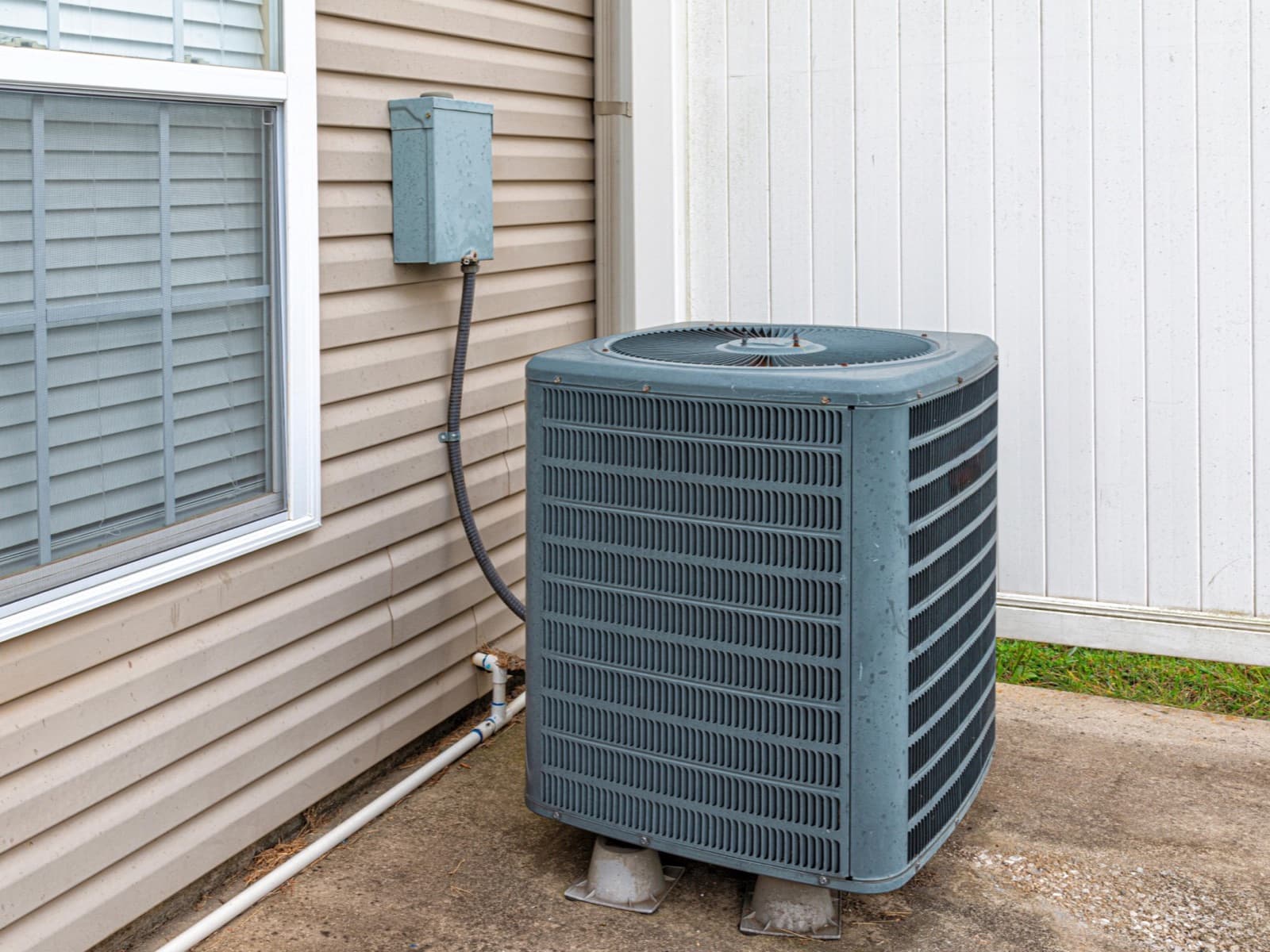 AC unit on slab beside siding.