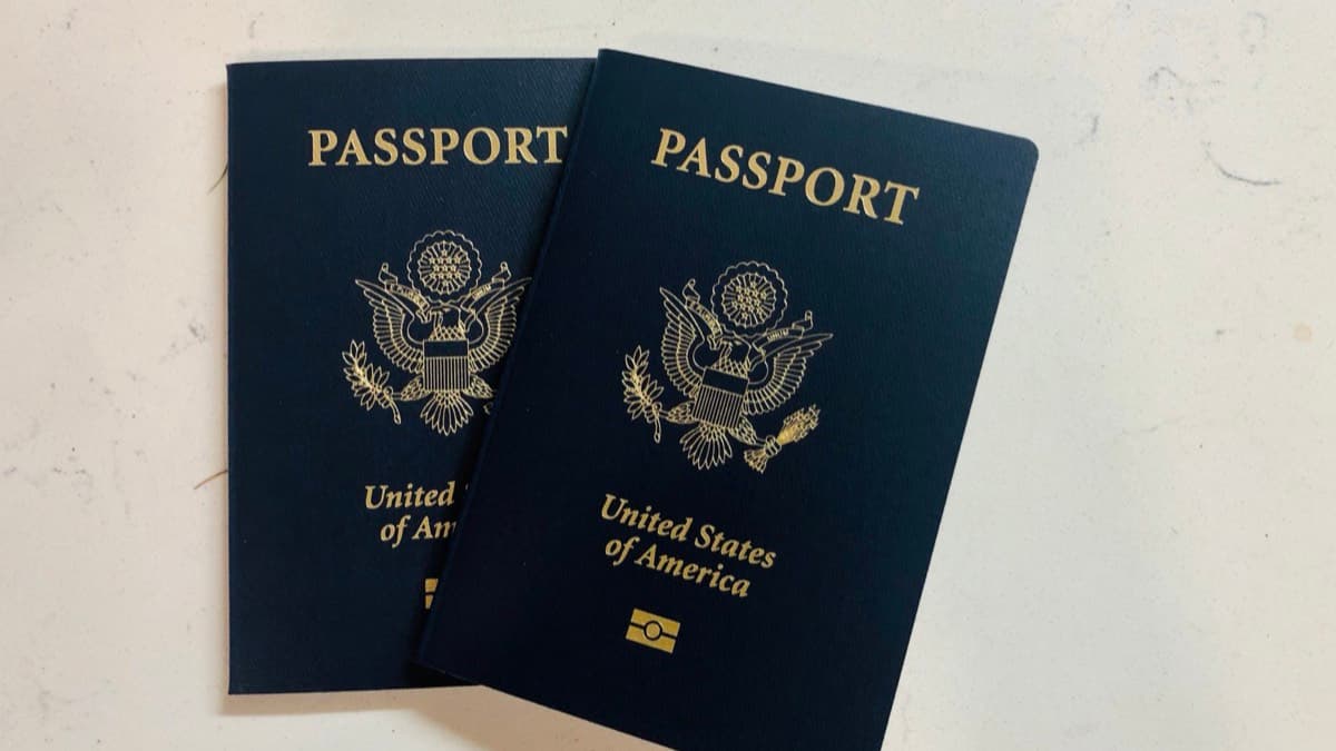 Two United States passports on a white surface
